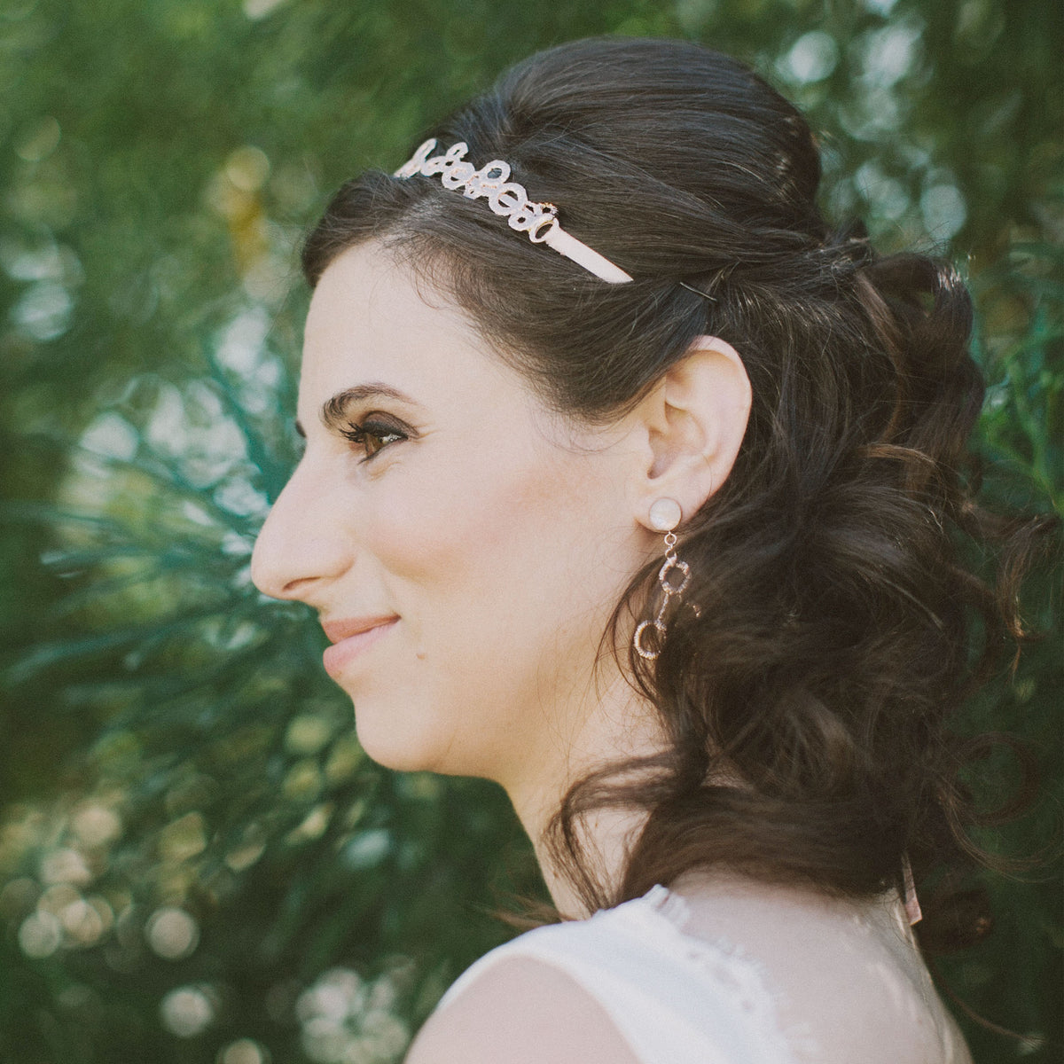 Model showing original lace tiara solidified in rose gold with silk ribbons.