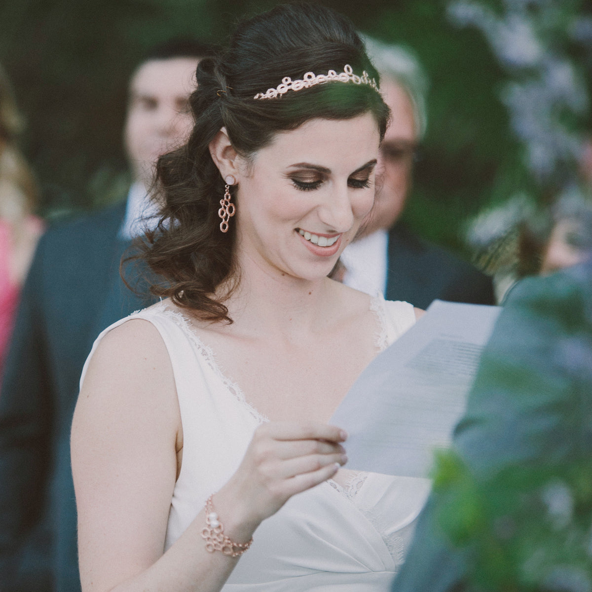 Exquisite chain bracelet with two pearls and a circular lace front dipped in rose gold on model.