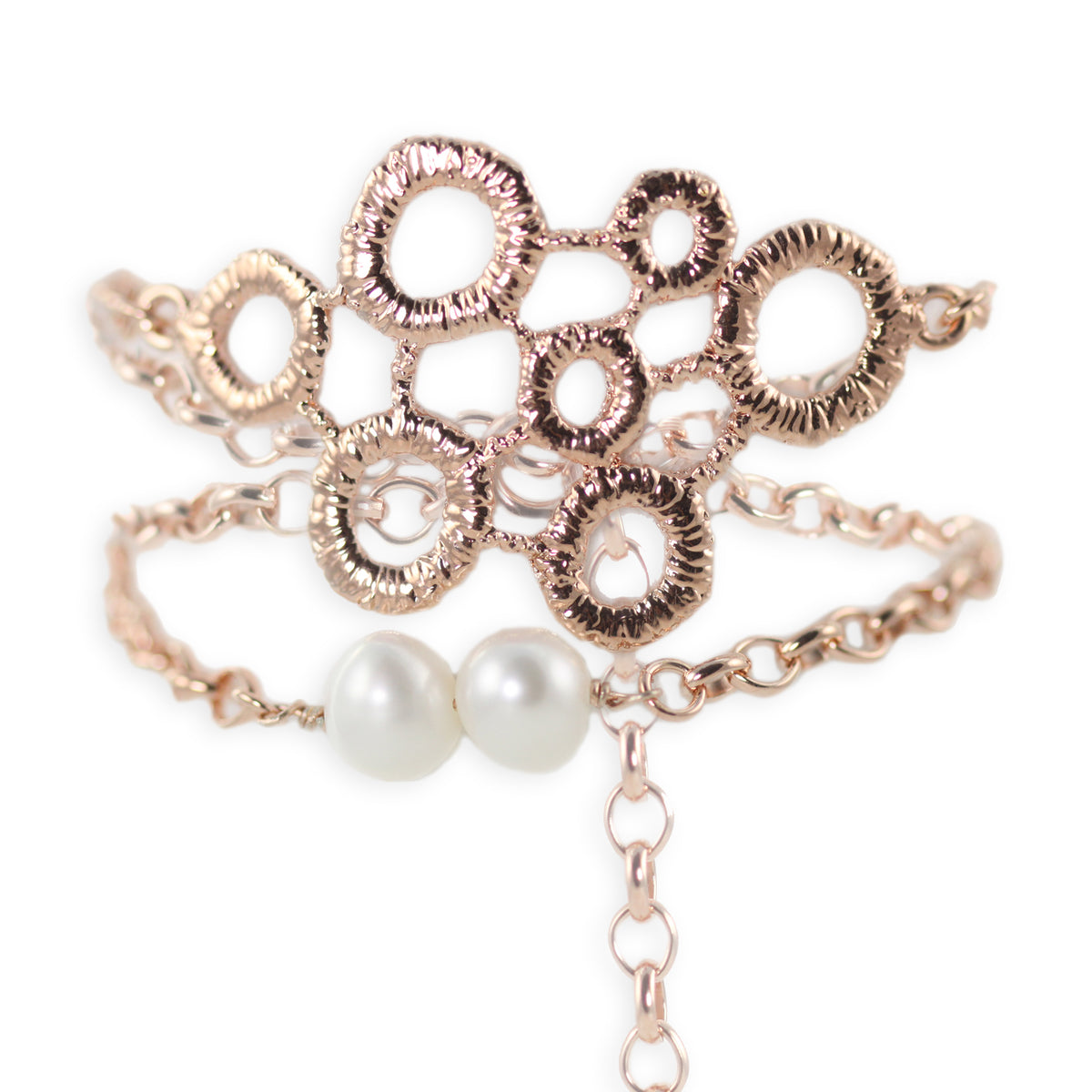 Exquisite chain bracelet with two pearls and a circular lace front dipped in rose gold.