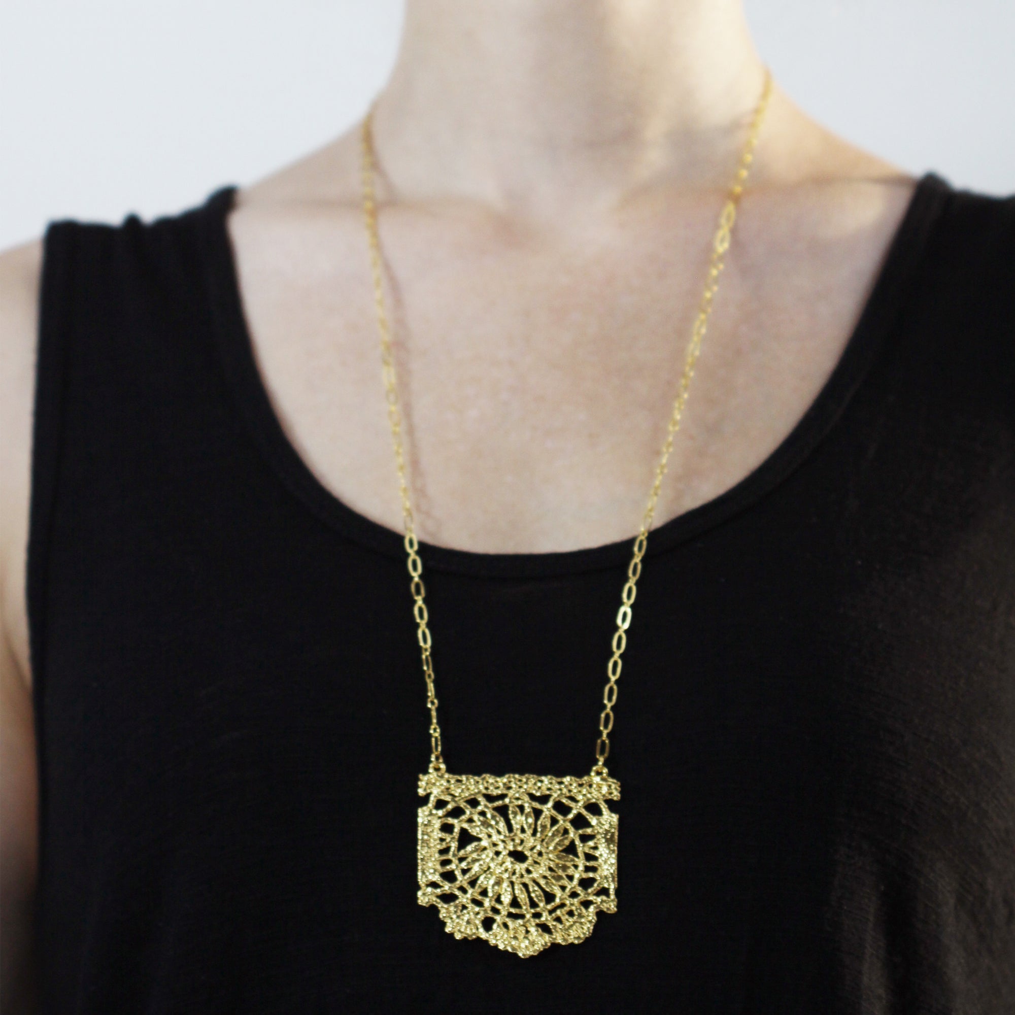 Rare and intricate necklace with lace pendant in dipped 24k gold.