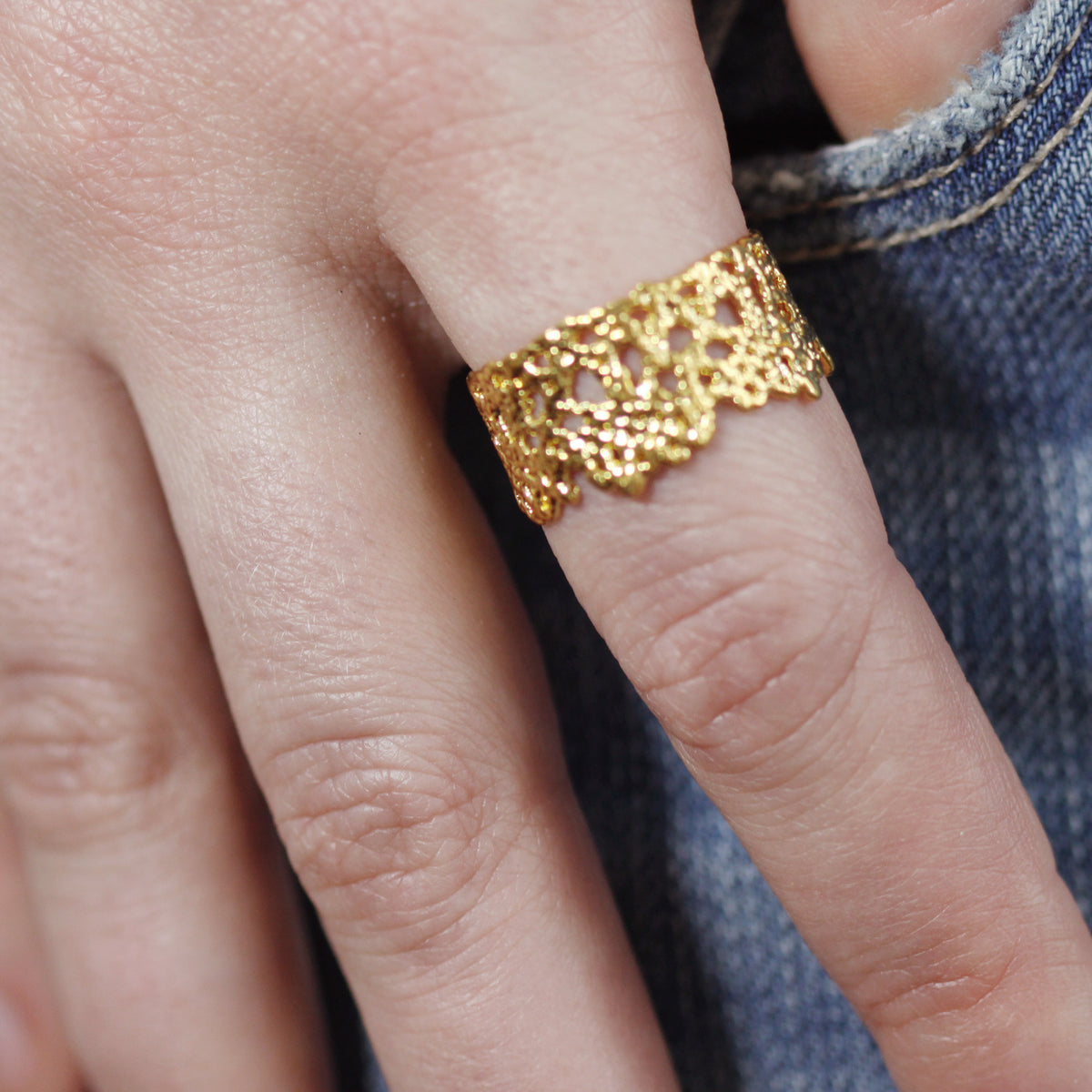 Model wearing lace crown ring in 24k gold with real lace inside.