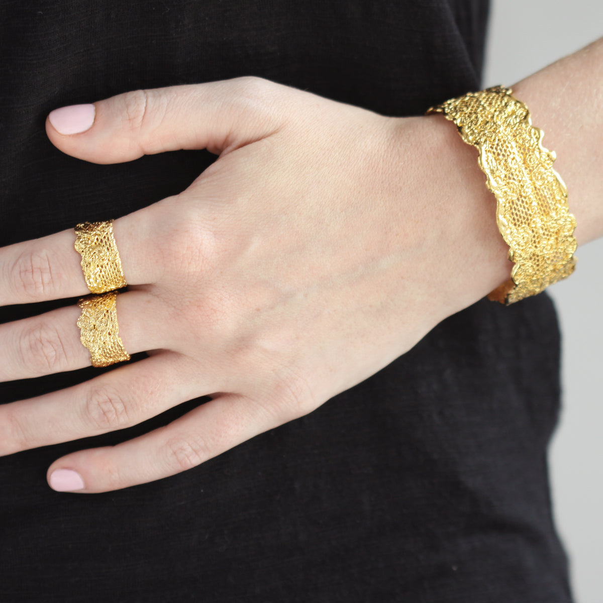 Marlene double scalloped lace bracelet in 24k gold worn by a model.