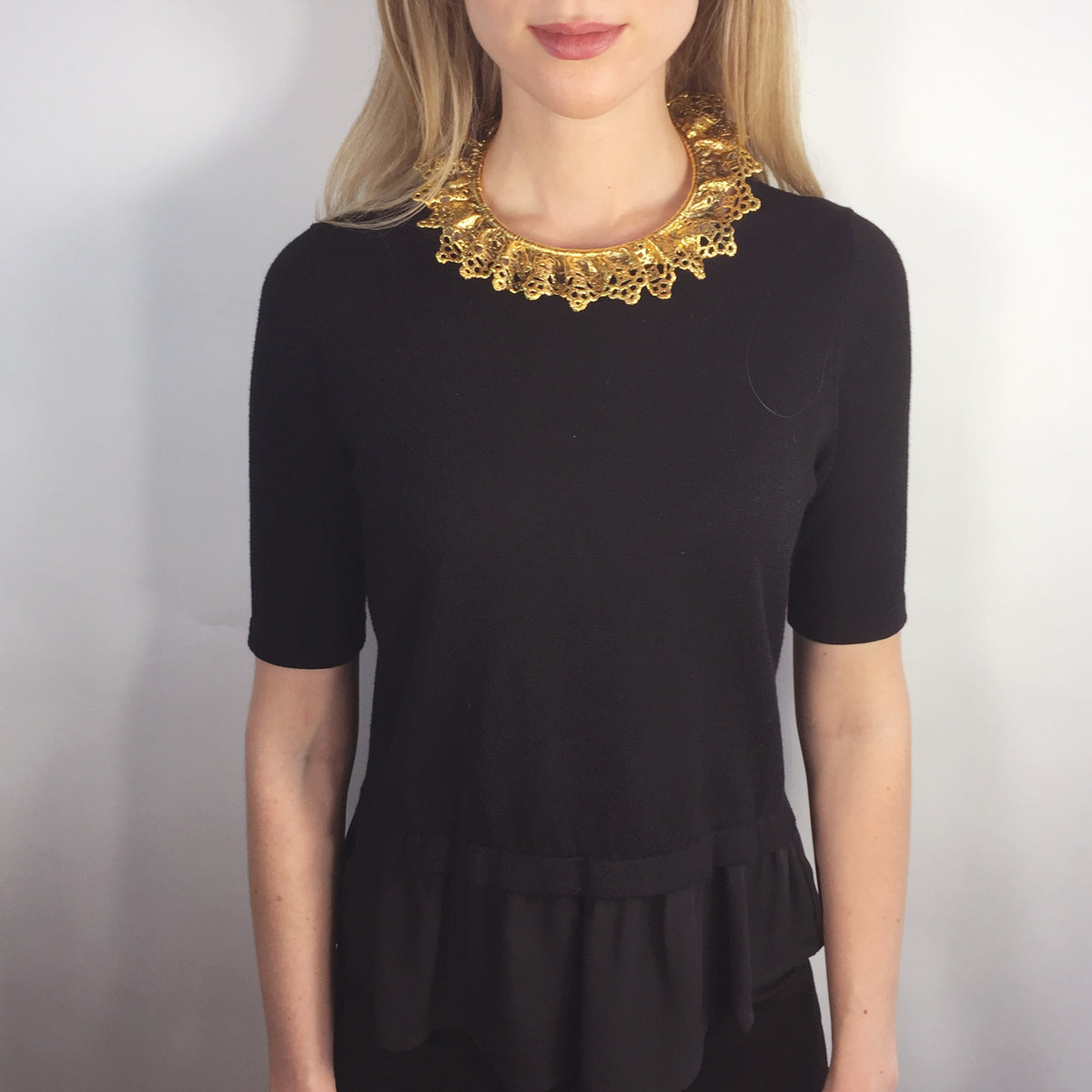 Lace choker dipped in 24k gold worn by a model.