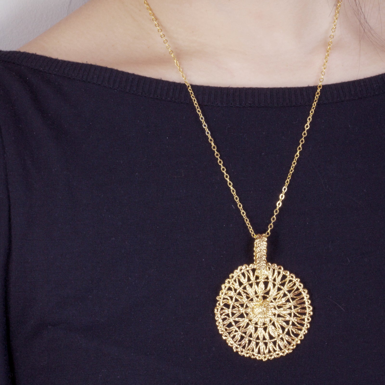 Rare round lace pendant necklace dipped in 24k gold.