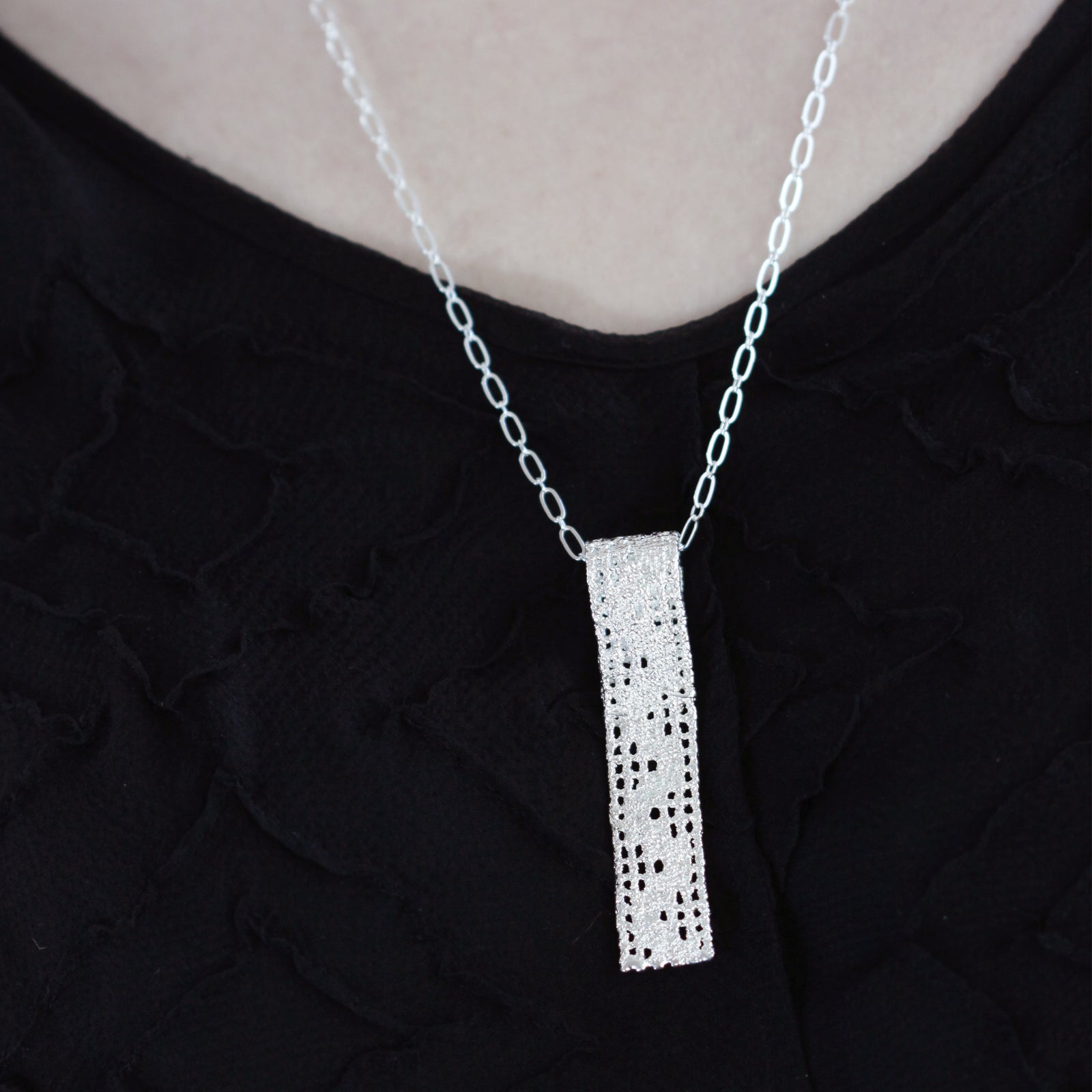 Lace pendant necklace solidified in sterling silver.